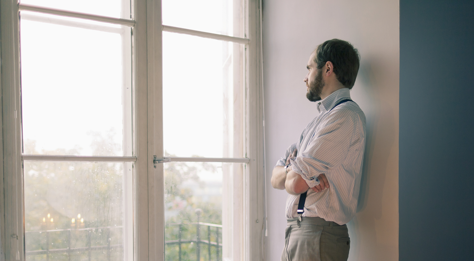 man-looking-out-of-window